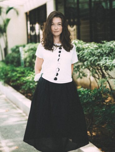 woman wearing black skirt standing beside plants